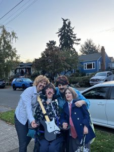 Halloween costume family photo, with three people dressed as the Beatles with antenna, the fourth in boarding-school costume.
