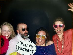 Four goofy people in a photo booth