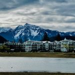 Hotel and condo in front of glaciated mountain peaks